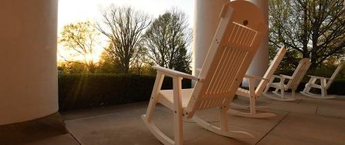 white rocking chairs on the porch of Old Centre at sunrise